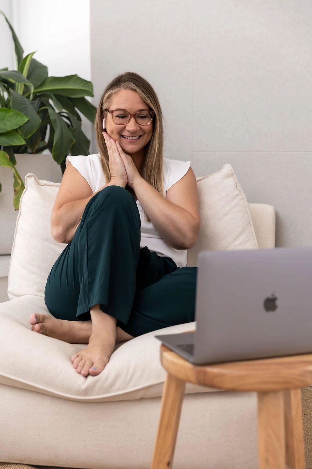 Woman smiling while video chatting on a laptop.