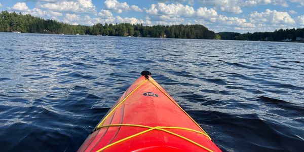 Kayak gliding over Higley Flow at Camp Lake Bear lakefront camp in Colton, New York