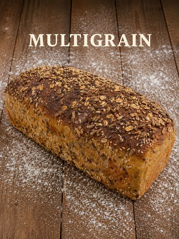 Loaf of multigrain bread on wooden surface.