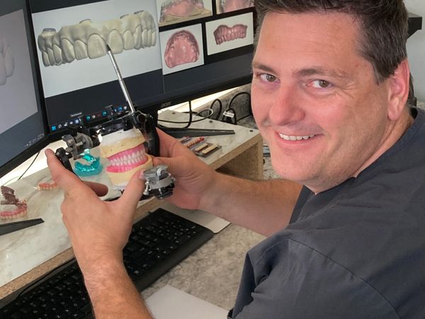 Danny Thornton holding a dental model