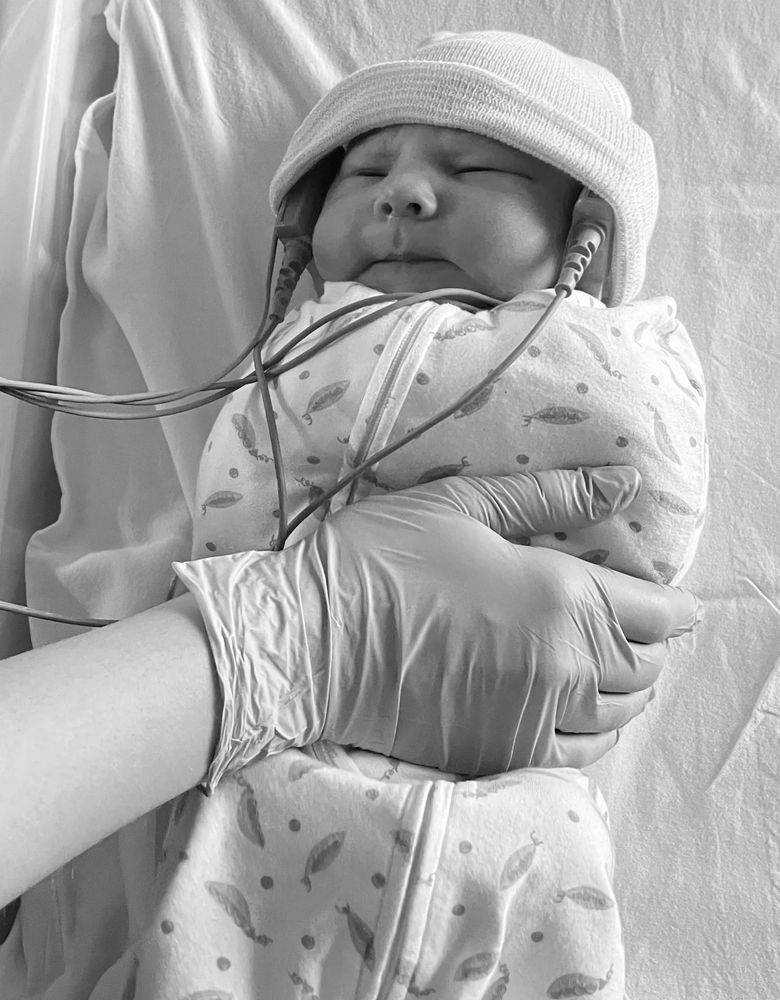 Newborn baby hospital hearing test with headphones on both ears