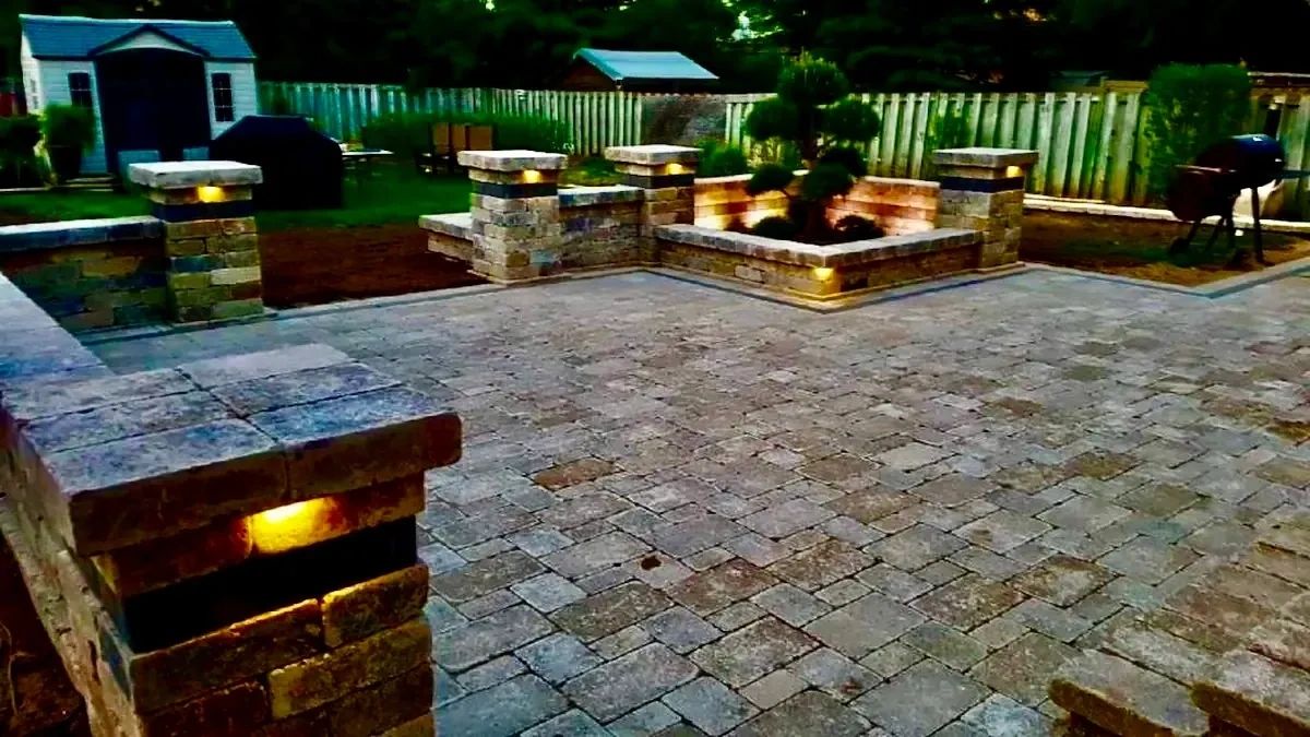 Backyard patio installation with proper slope away from house foundation