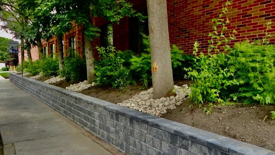 Retaining wall construction in Simcoe County Ontario with proper base and drainage support.
