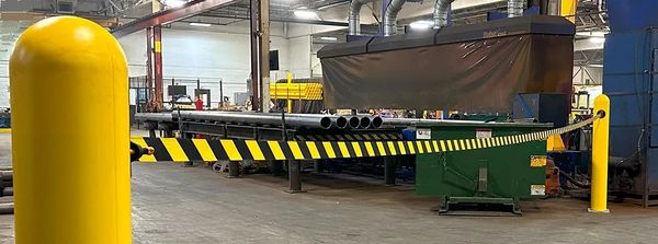 Yellow and black striped barrier tape inside a factory.