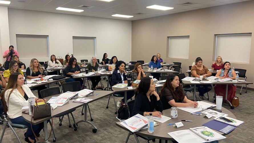 Women attentively participating in a classroom training session.