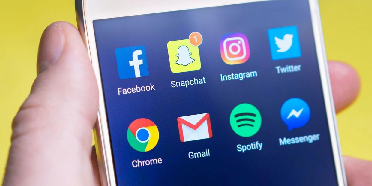 Close-up of a smartphone screen showing popular social media and app icons.