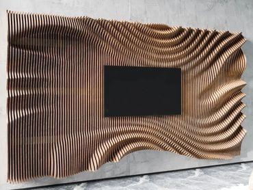 Modern wooden wall art with wavy, layered design surrounding a black rectangular centerpiece.