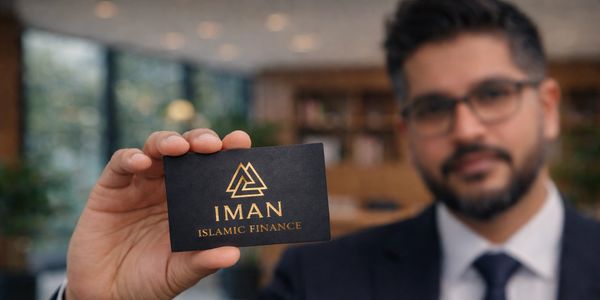 Man holding a business card for Iman Islamic Finance.