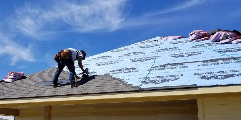 Roofer repairing shingles on a home for our customer