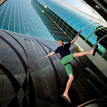 Senior portrait jumping between high rise buildings on Perdido Key, Fl