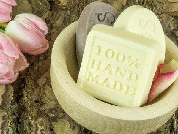 three soaps in a wooden bowl.