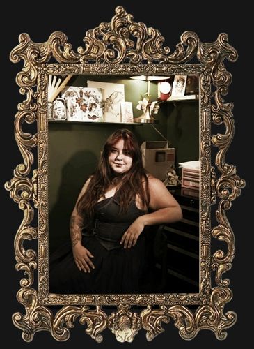 Woman posing in an ornate vintage frame.
