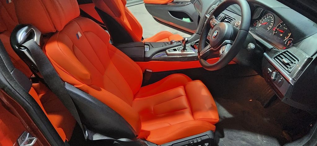 Upholster of Nappa Leather done for this BMW. Customer chose bright Orange-Red Color. All the detail
