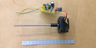 A simple stepper motor with a stepper driver (of our design) and a miniature precision power screw