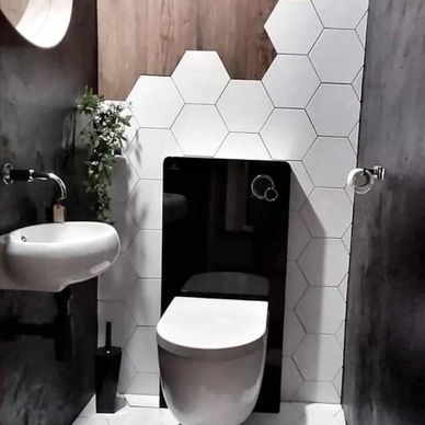Modern bathroom with hexagonal tiles blending into wood flooring.