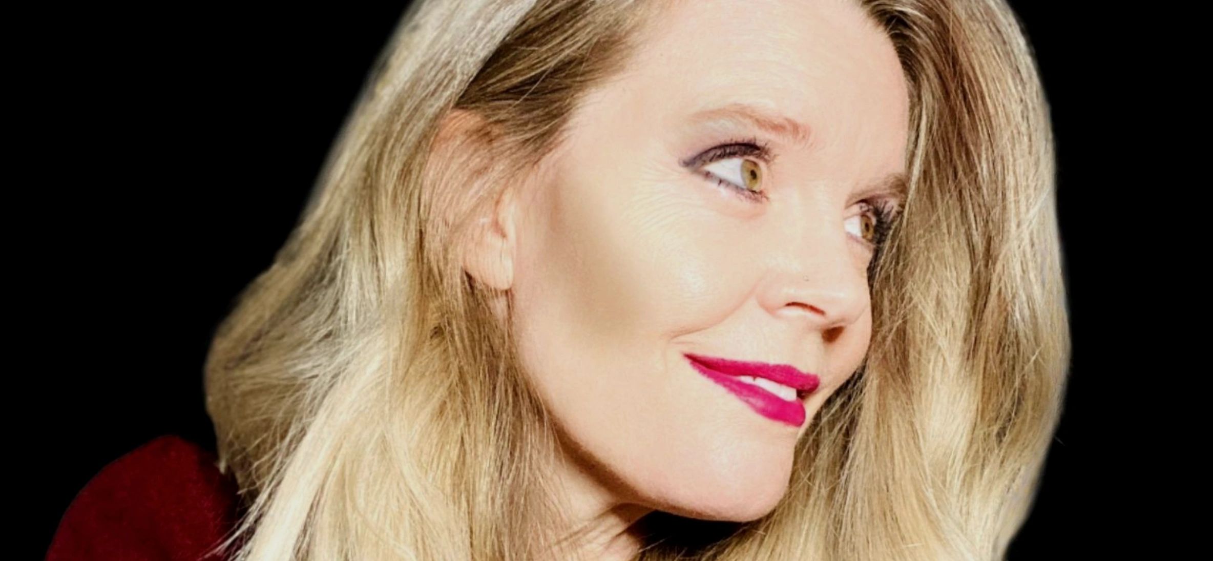 Blond woman with red lipstick looking off to the side