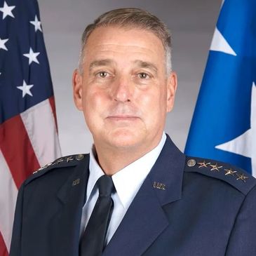 Portrait of a military officer in uniform with American flag background.