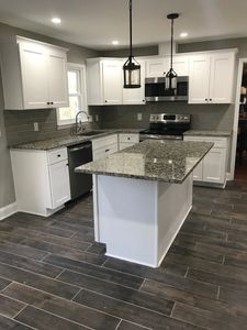 New kitchen with white cabinets and granite countertops Alpharetta, GA. Rocky Brook Construction. 