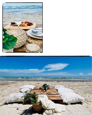 A cozy beach picnic setup with cushions and a low table by the ocean.