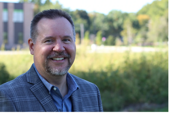 Iowa House Candidate Jason Menke in front of the brand-new Valerius Elementary School.