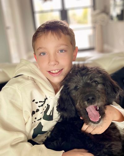 Black Aussiedoodle with Kid