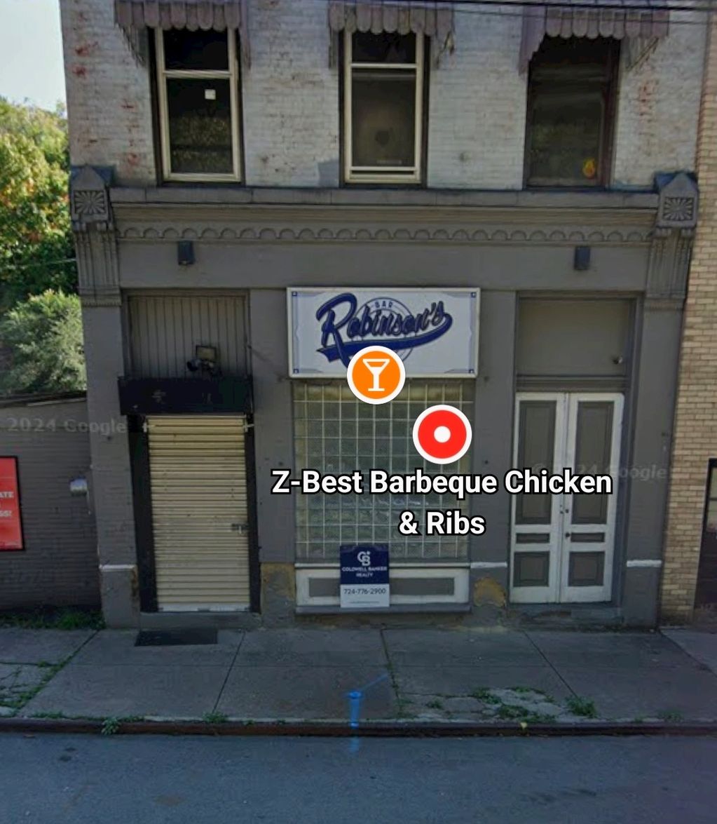 Closed storefront with Robinson's Bar sign and Z-Best Barbeque Chicken &amp; Ribs label.