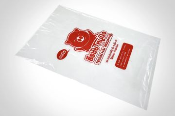 Plastic bag with a red bear logo and text.