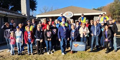 Group of people posing outdoors for a community event photo.