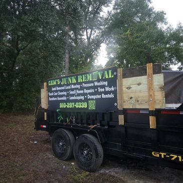 A trailer with a sign advertising junk removal and related services.