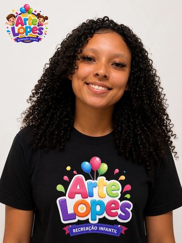 Smiling woman with curly hair wearing a colorful 'Arte Lopes' children's recreation t-shirt.