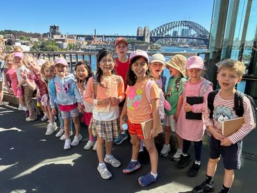 Group of children on a sunny outing with Sydney Harbour Bridge in the background.