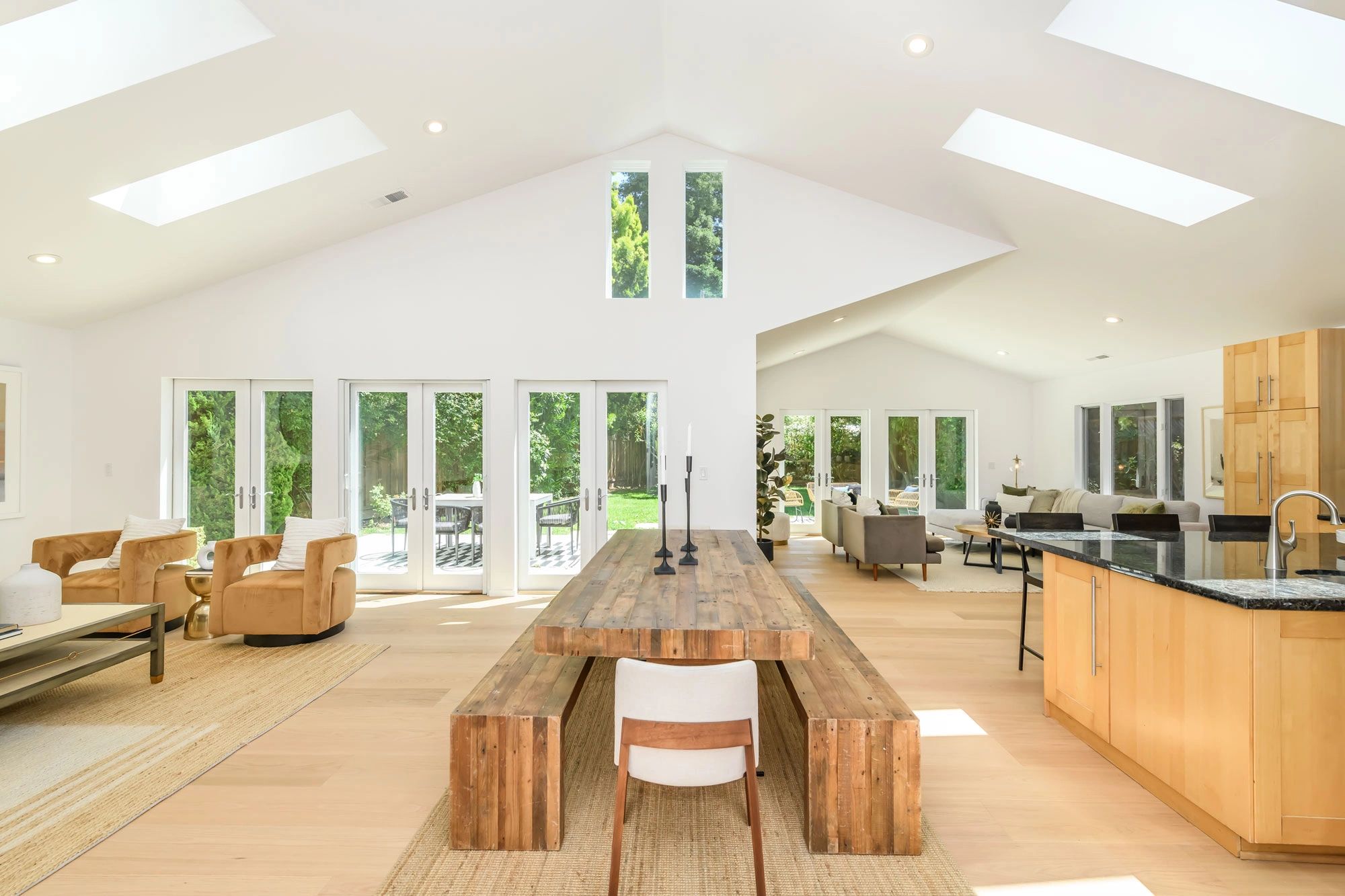 Spacious modern living and dining area with natural light and wooden furniture.