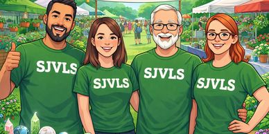 Four people in green SJVLS shirts smiling at a garden event.