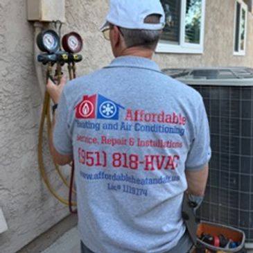 HVAC technician performing a heat pump tune-up.