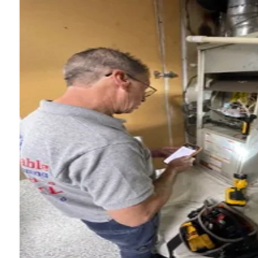 Affordable Heating and Air Conditioning technician inspecting a furnace control board and wiring to 