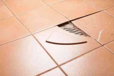 Broken floor tile with a missing piece.