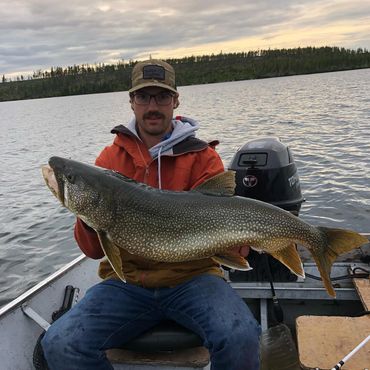 Lake trout fishing at dusk in late summer at Crystal Lodge on Cree Lake 