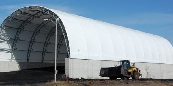 Hoop structure on concrete wall  for material storage by construction tent rentals