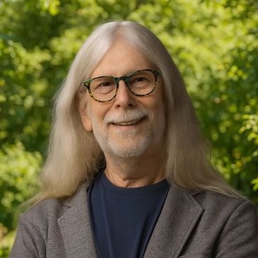 Smiling elderly man with long white hair and glasses outdoors.