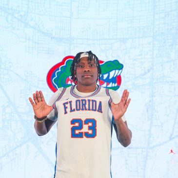 Basketball player in Florida Gators jersey number 23 posing with hands raised.