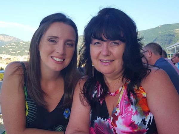 Stacey & Christine (2 Women) sat smiling at the camera