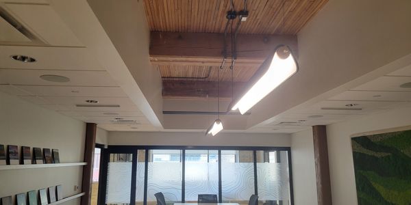 Modern conference room with a long table and ceiling lights.