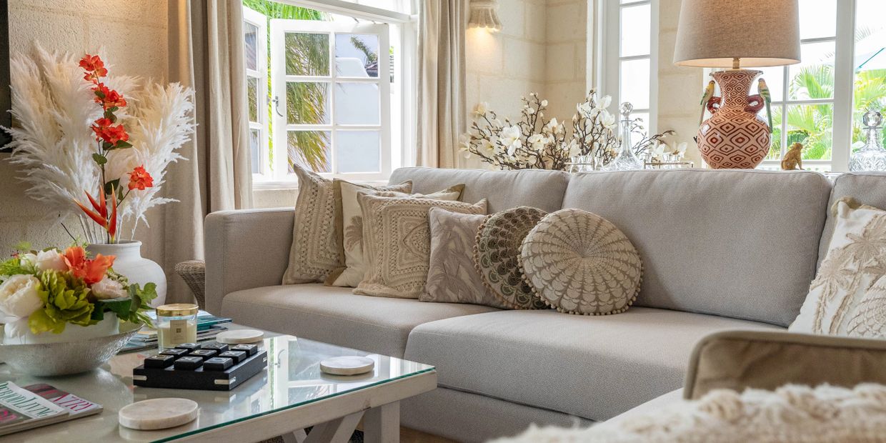 Elegant living room with neutral sofa and vibrant floral accents.
