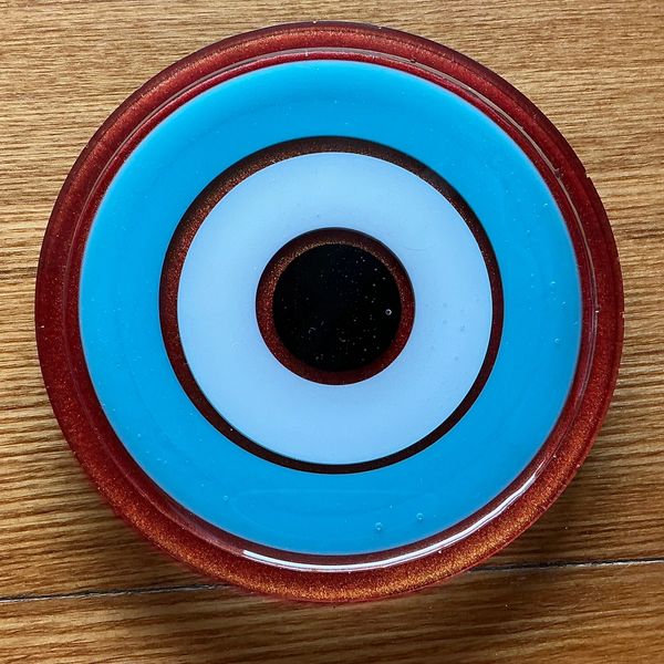 Blue and black circular design on a wooden surface.