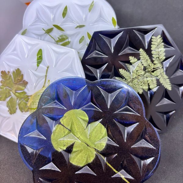 Decorative glass plates with embedded leaves.