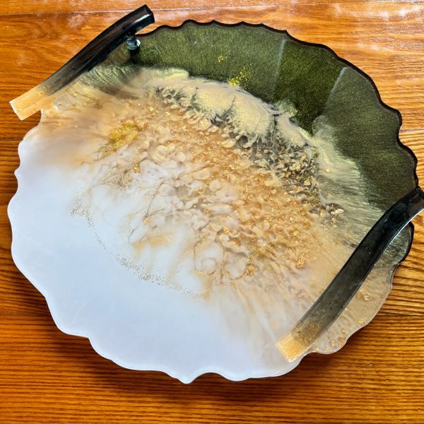 Decorative resin tray with black handles and gold speckles.
