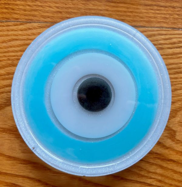 Blue and white circular object on wood.