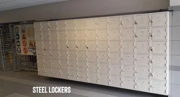 A large set of white steel lockers in a hallway.