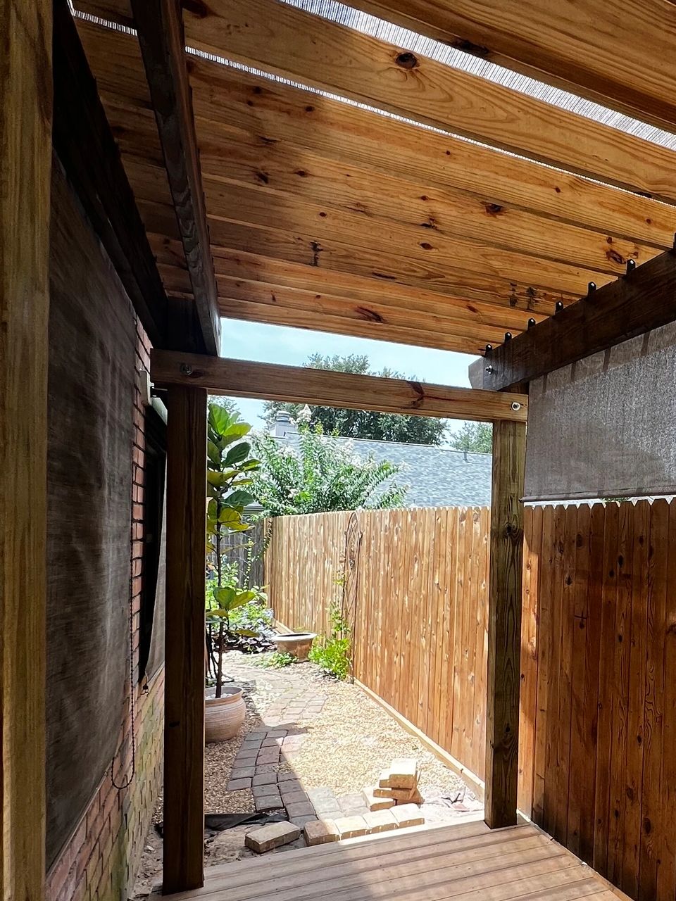 Natural Wood Pergola and Composite Deck after fence replacement.