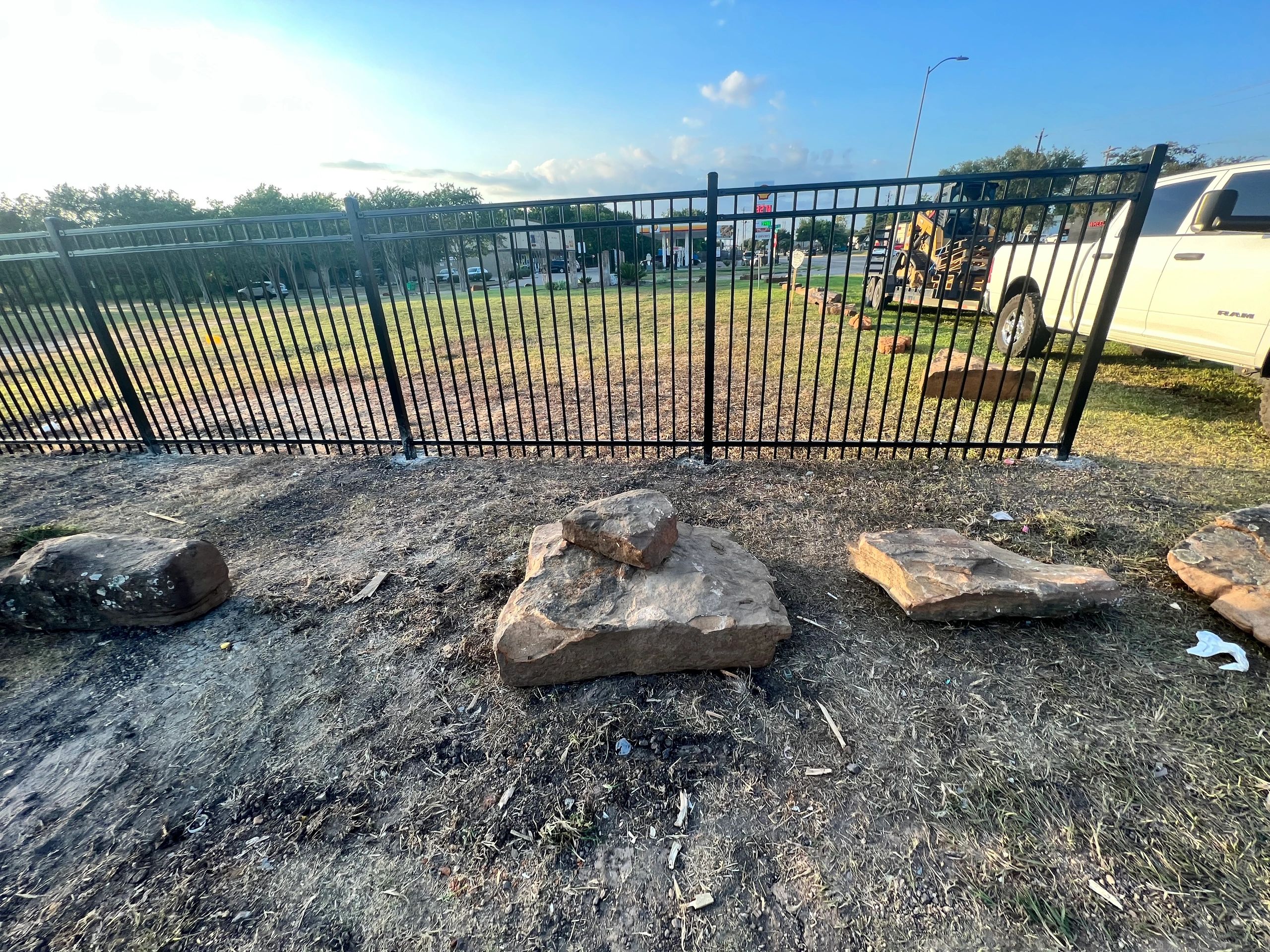 Wrought Iron fence and boulder installation.